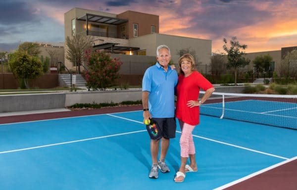 couple on tennis court at Trilogy by Shea Homes in Summerlin