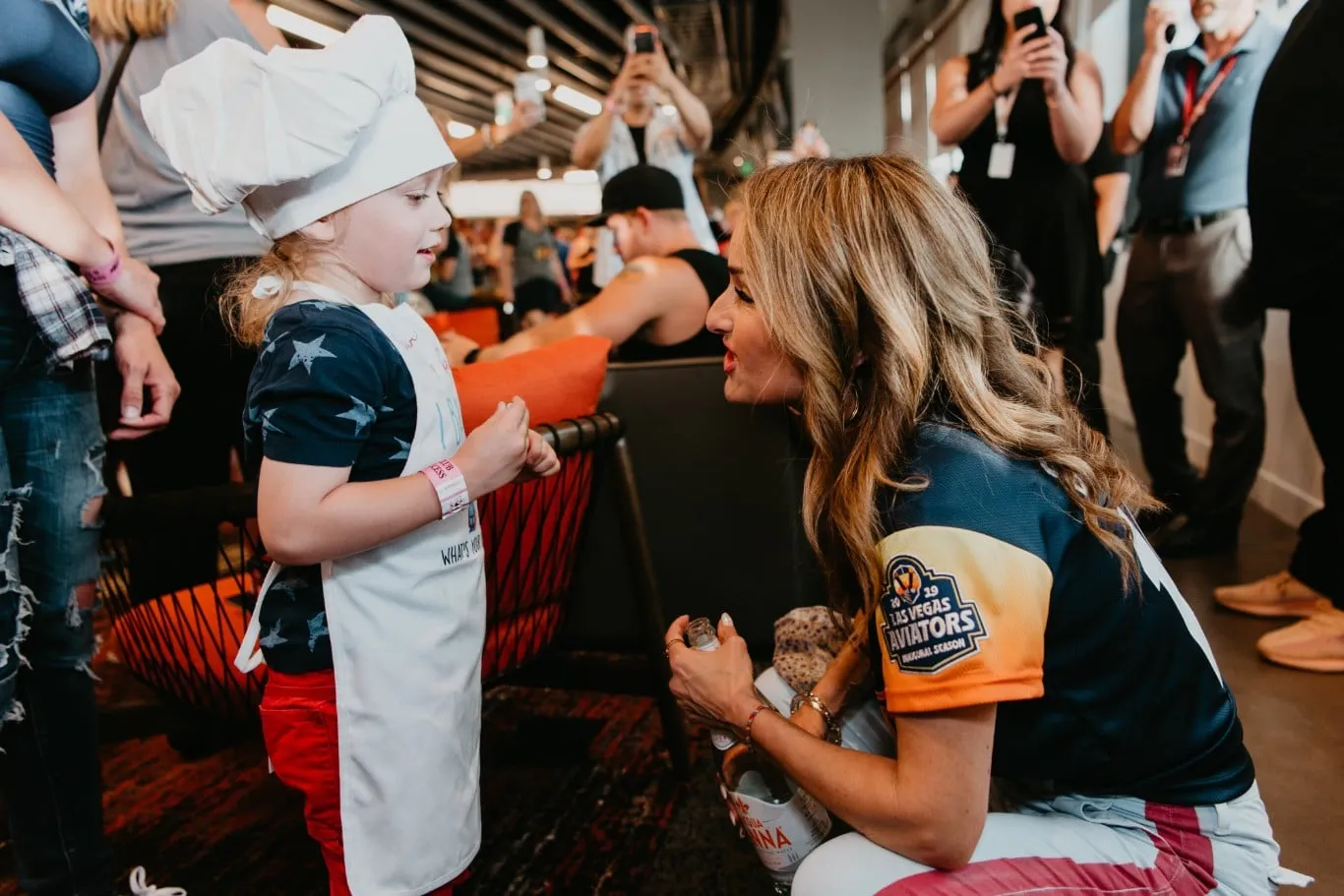 Giada with young girl in chefs hat at Las Vegas Ballpark
