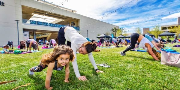 Mom and daughter doing yoga at the Wellness Festival in Downtown Summerlin