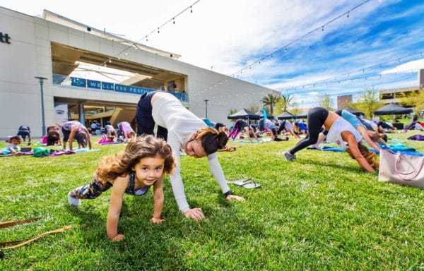 Mom and daughter doing yoga at the Wellness Festival in Downtown Summerlin