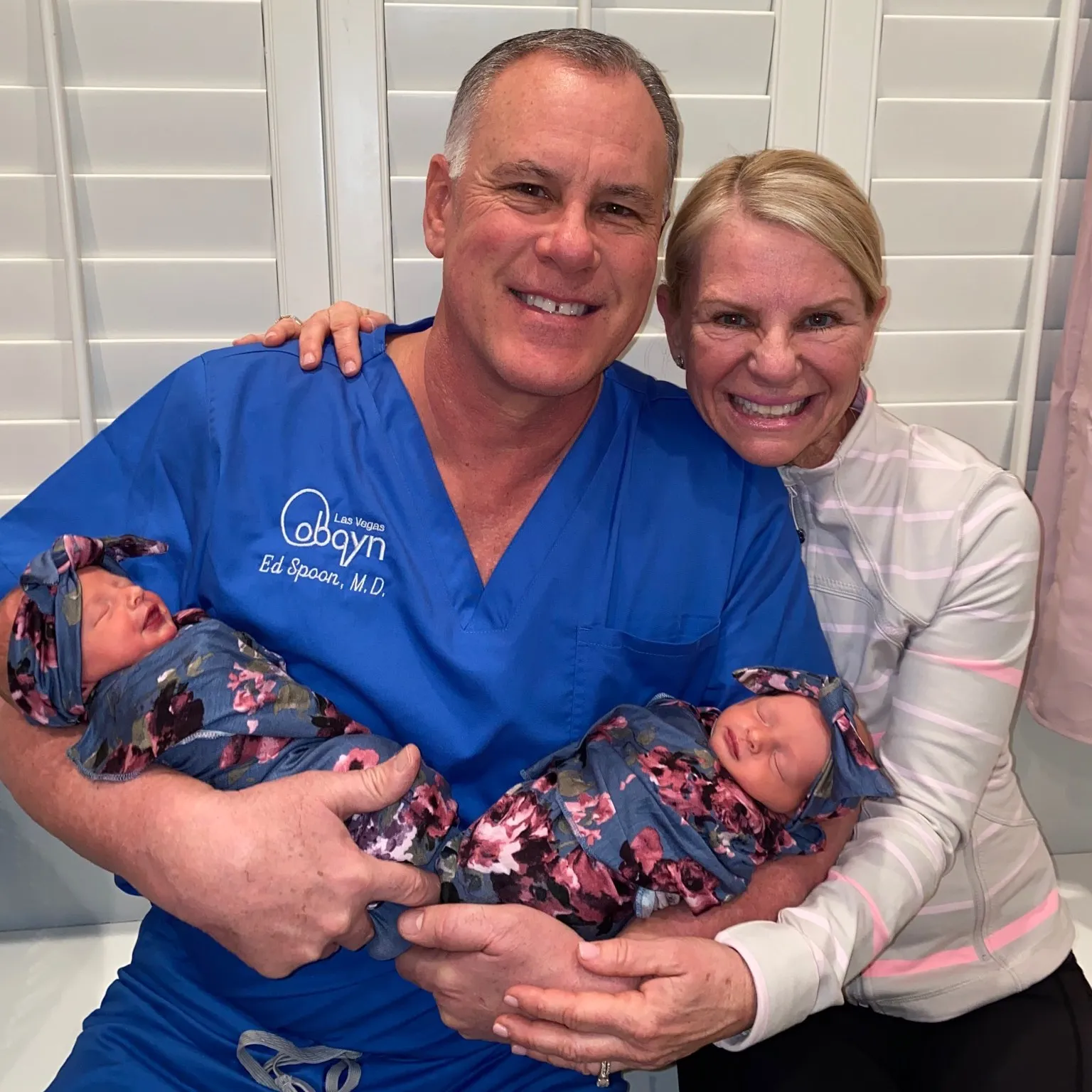 Dr Ed Spoon and wife holding their grandkids