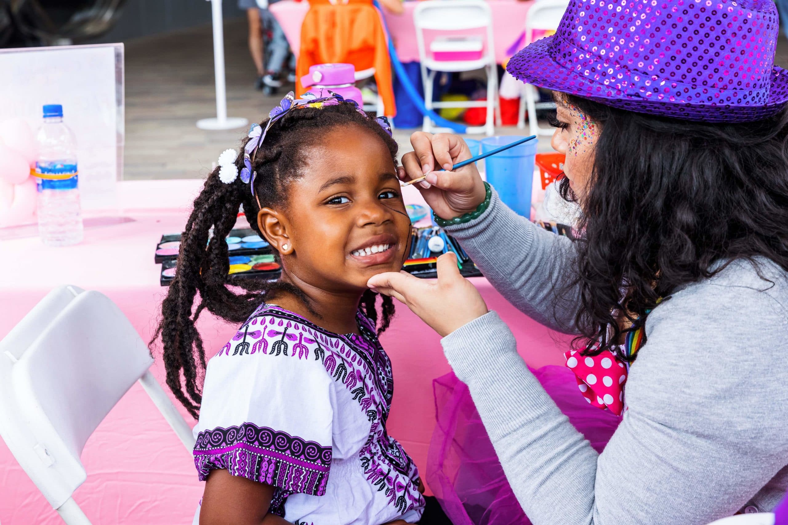 Little girl getting her face painted