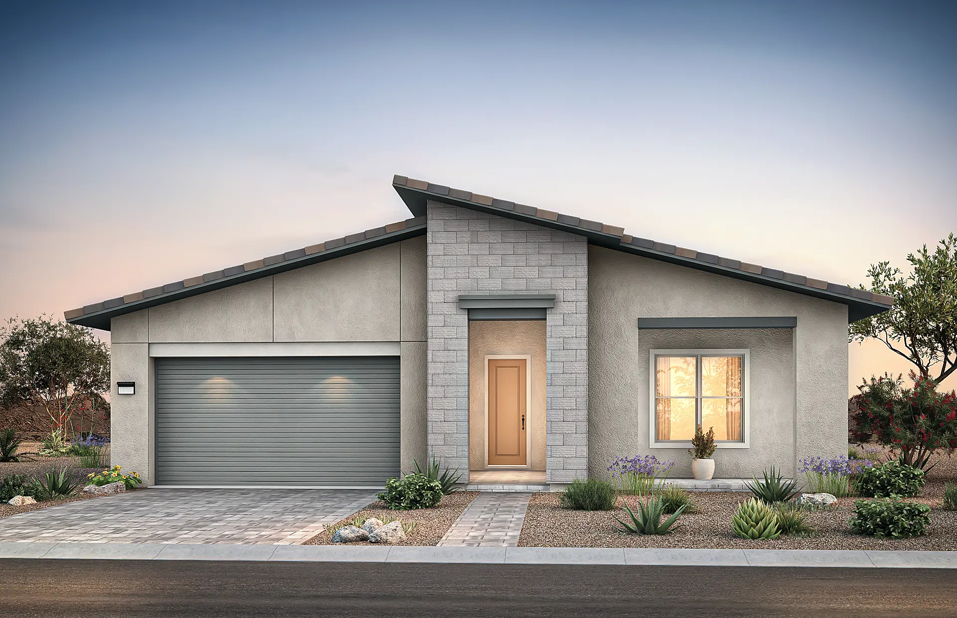 4522-7-Gardengate-C8 Modern single-story house at Gardengate at Brantley by Pulte Homes with a sloped roof, gray exterior, two-car garage, central front door, large window with warm light, desert landscaping, and paved driveway at dusk.