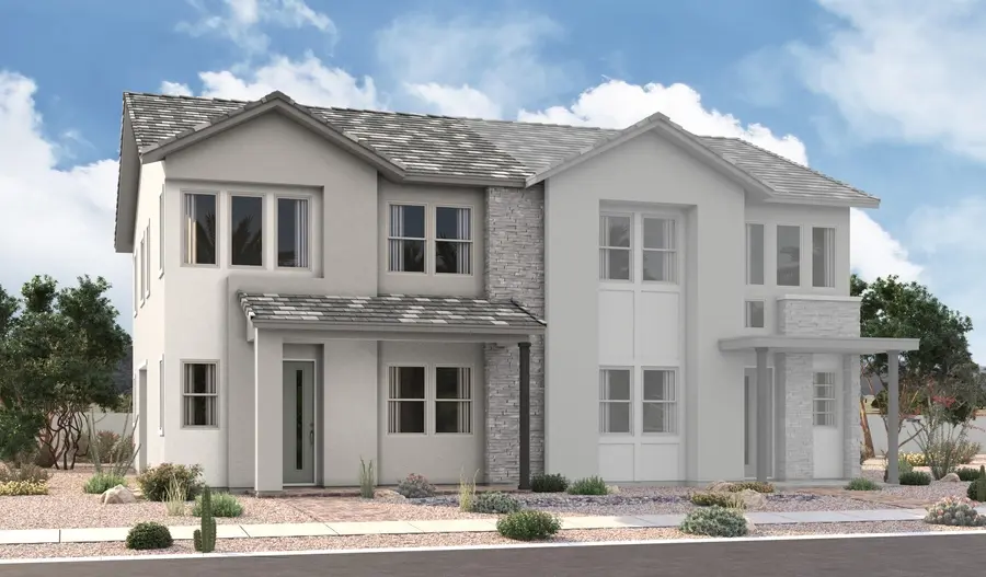 Navy-2-Elevation-B Modern two-story house with light gray and white exterior, stone accents, large windows, and a covered entrance, surrounded by desert landscaping and under a partly cloudy sky.