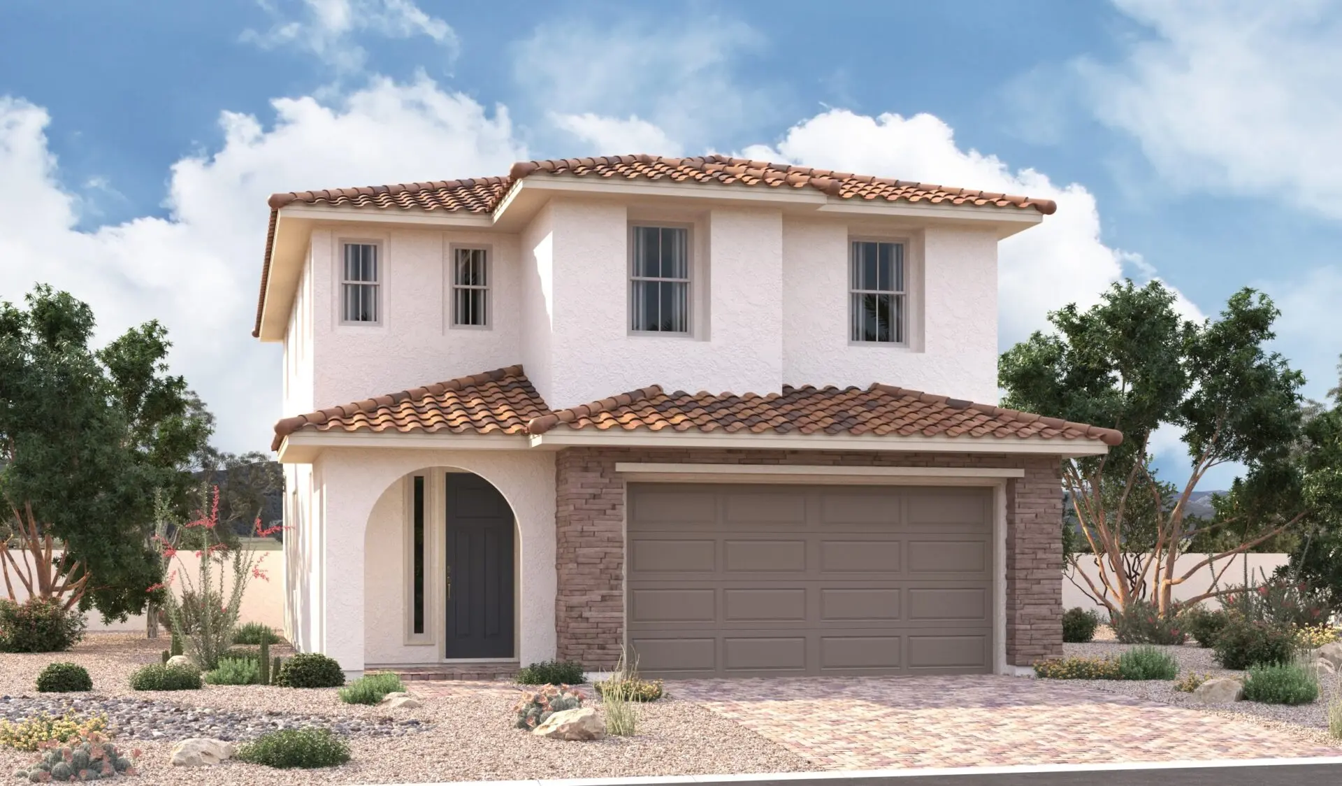 A two-story house with white stucco walls, a red tile roof, a double garage door, and an arched entryway, surrounded by desert landscaping and small trees under a partly cloudy sky.