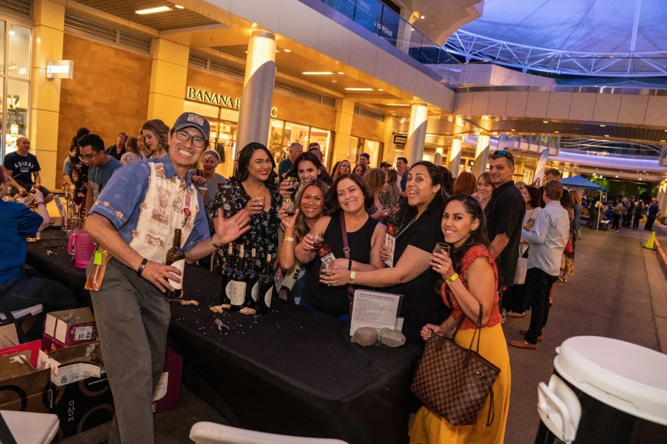 people smiling with wine at the New Vista Wine Walk at Downtown Summerlin