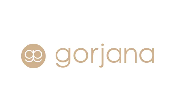 Gorjana Logo for Website Directory Gorjana logo with a beige gg emblem in a circle followed by the word gorjana in lowercase beige letters on a white background.